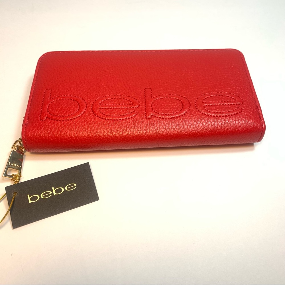 NWT. bebe red zip around wallet. Bebe logo embossed on front.